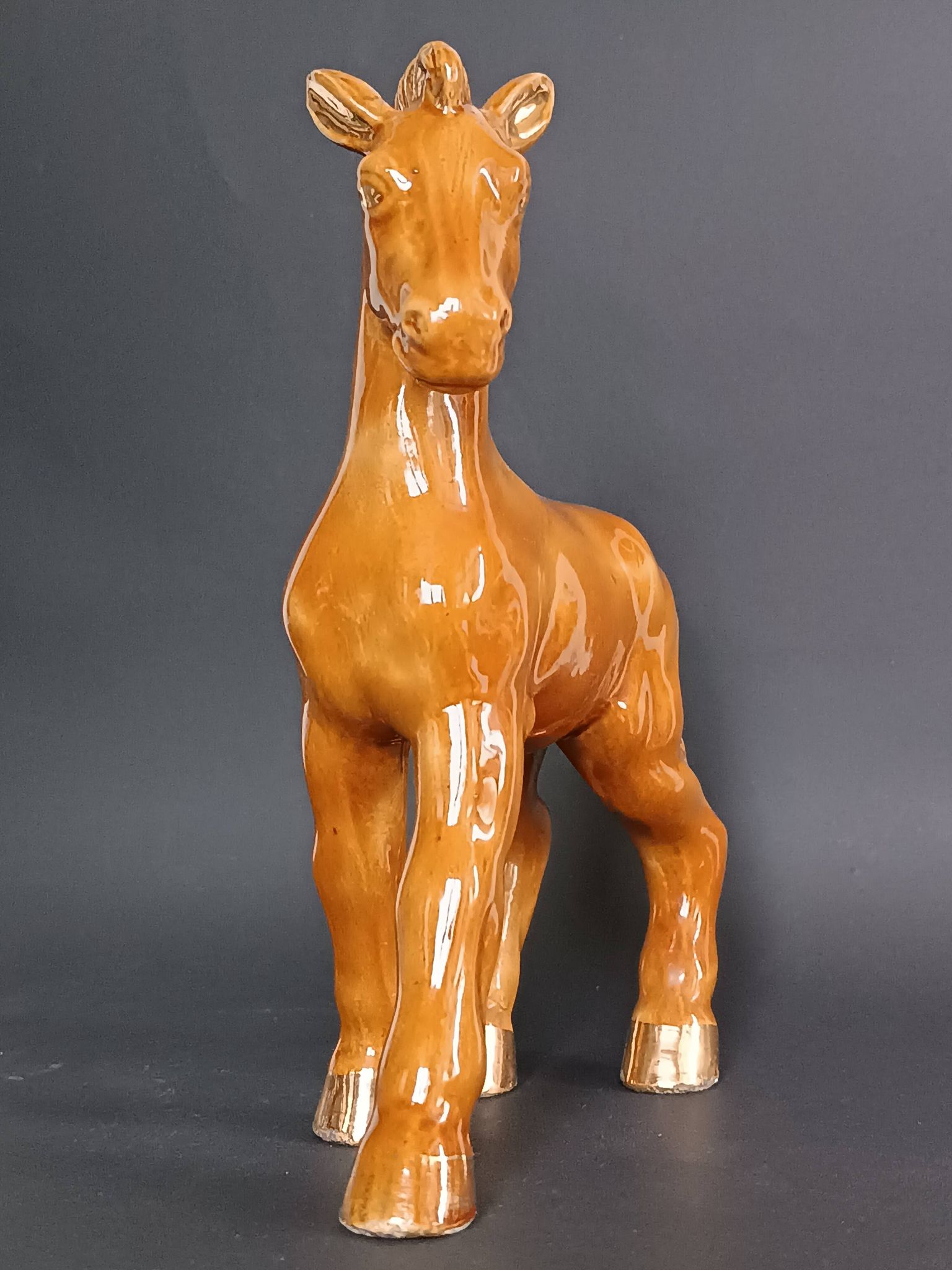 Ceramic horse sculpture with wild glaze and gold, signed Art Deco.