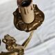 Vintage wall sconce in gold metal with two arms in classic style.
