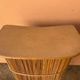 Vintage rattan bar from the 60s with rounded shapes and a shelf for glasses