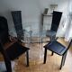 For sale: bevelled glass table and Artedi leather chairs.