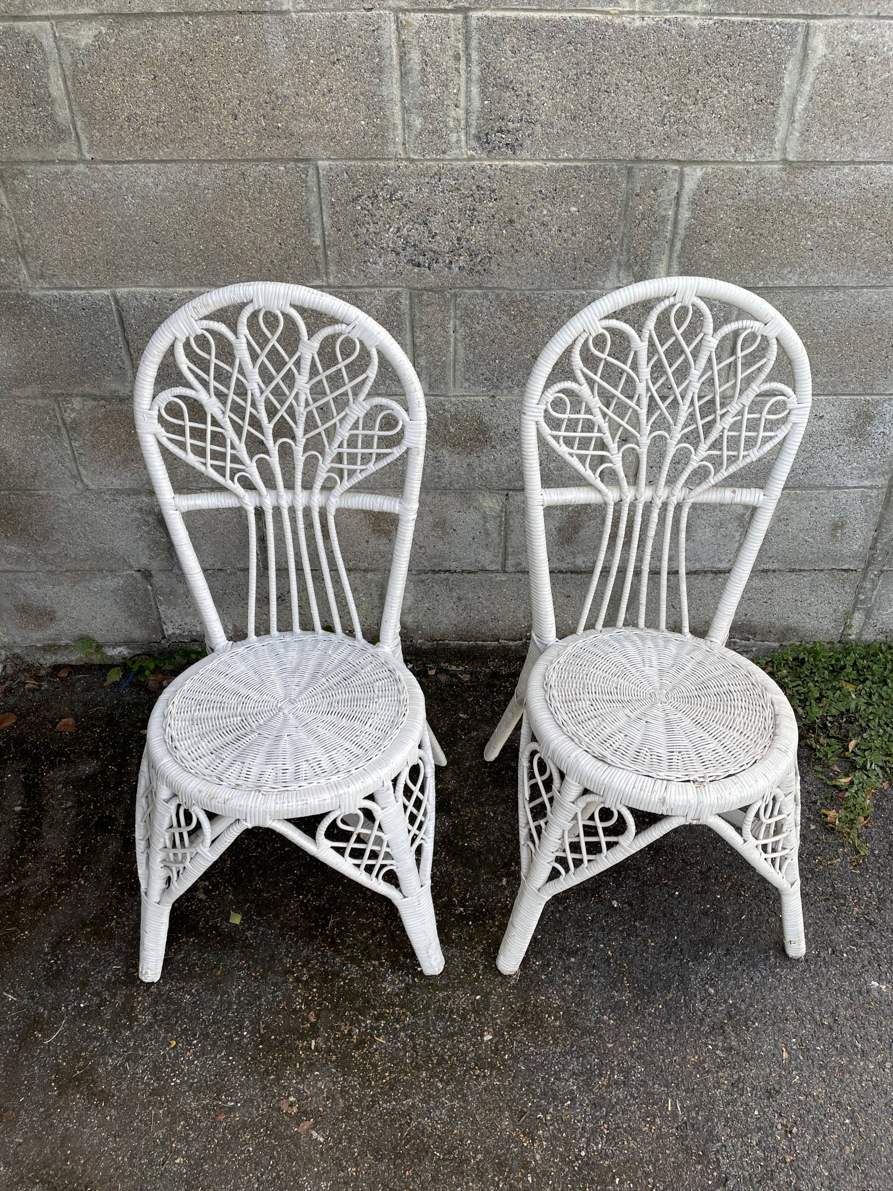 Pair of white peacock rattan chairs, circa 1960