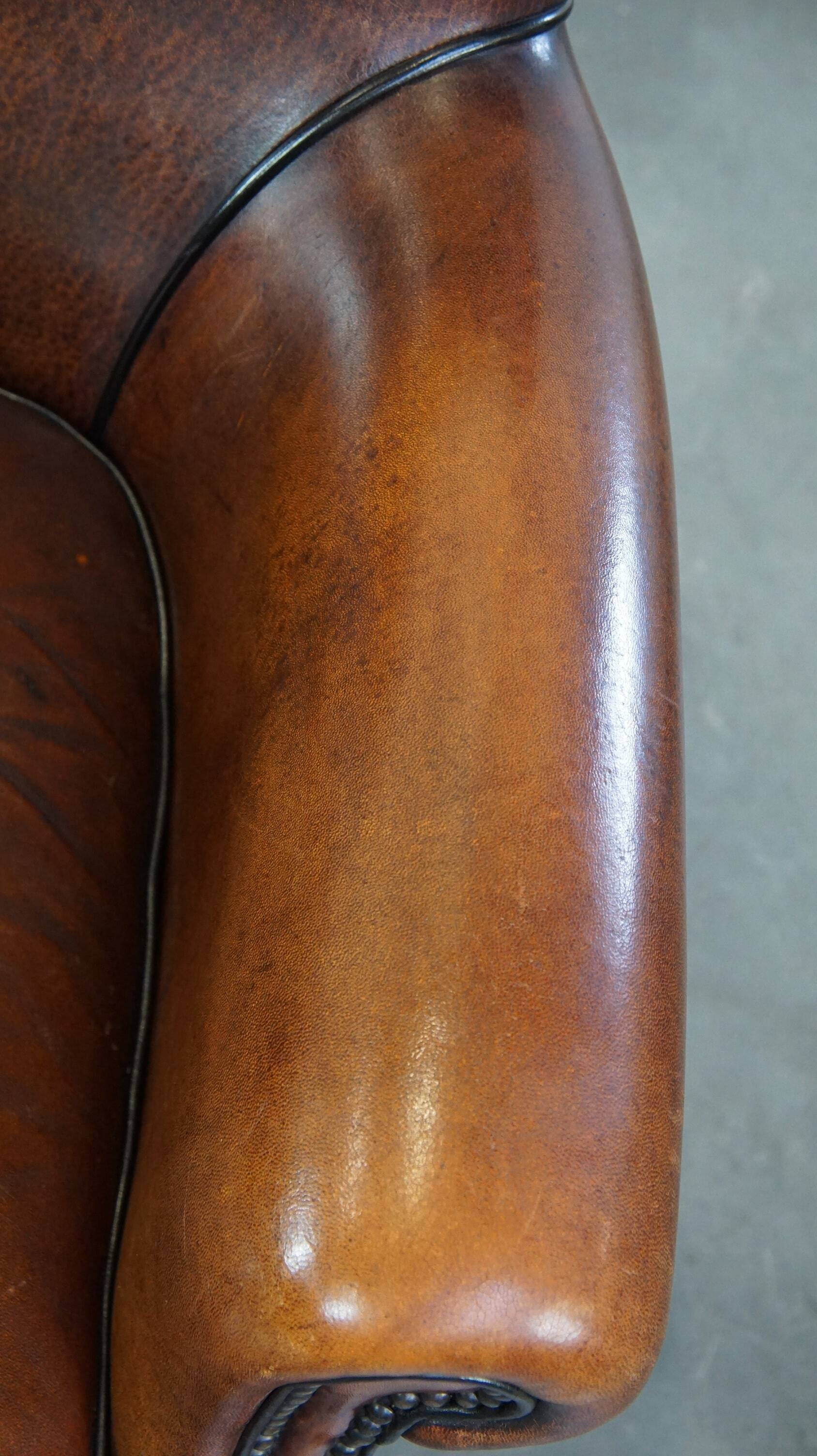 Sheepskin armchair/lounge chair finished with decorative nailheads