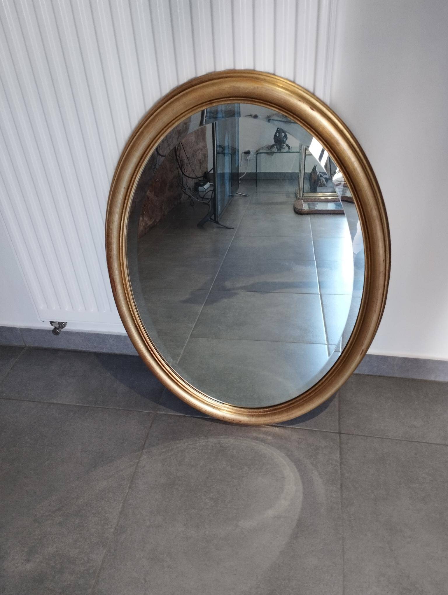 Grand et élégant miroir doré ovale avec sa glace biseauté