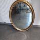 Grand et élégant miroir doré ovale avec sa glace biseauté