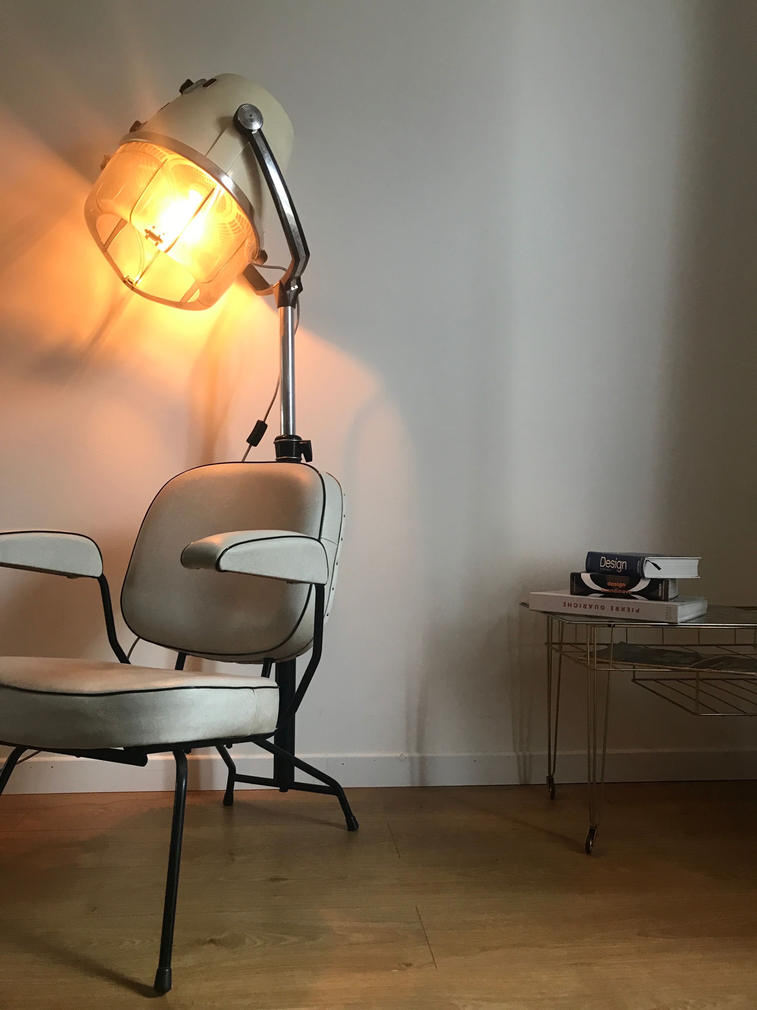 Vintage hairdresser's armchair with helmet transformed into a lamp