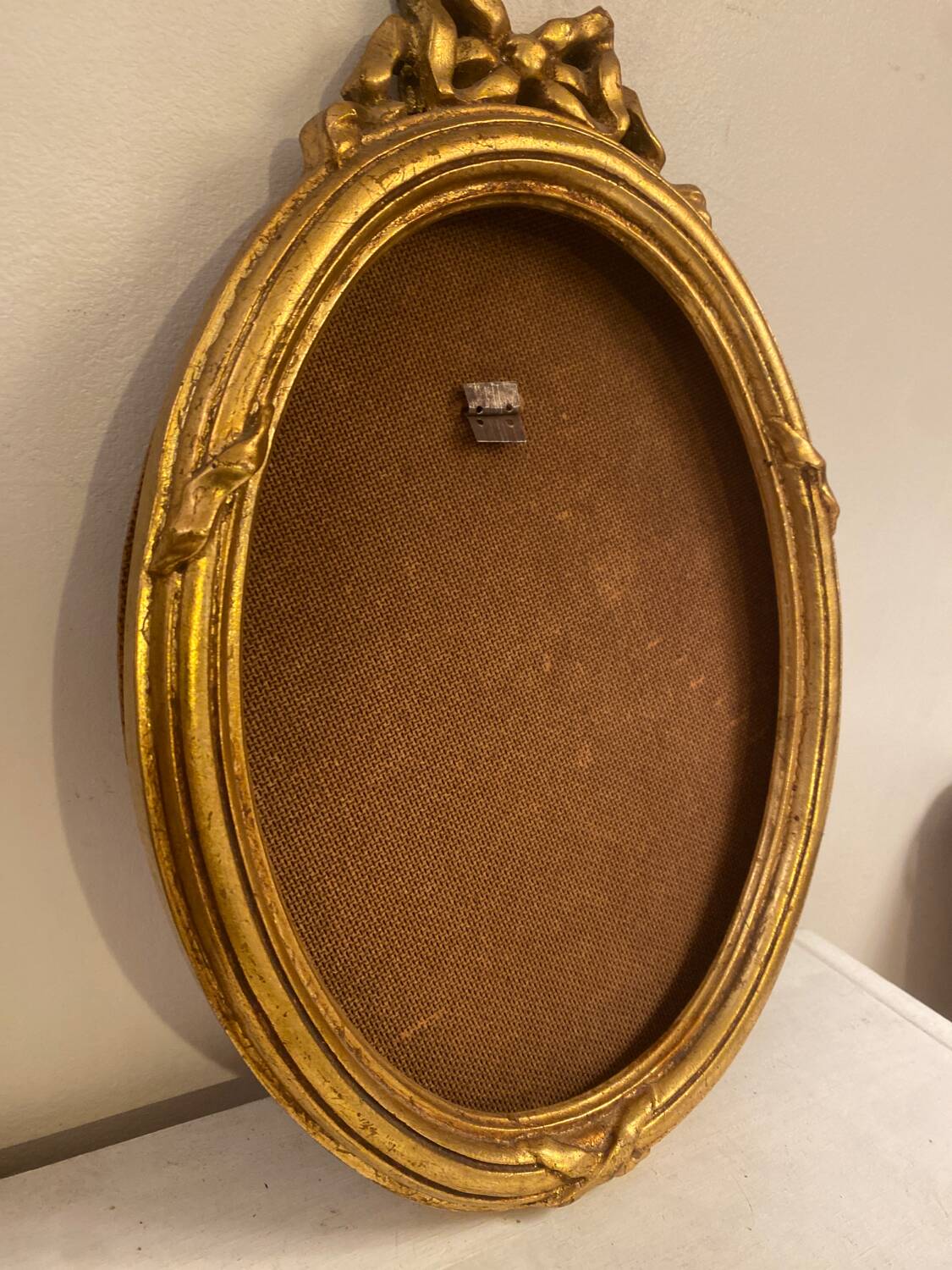 Golden oval wooden frame