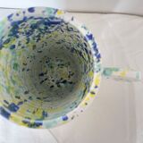 Green blue yellow speckled ceramic vase with abstract wool round handles