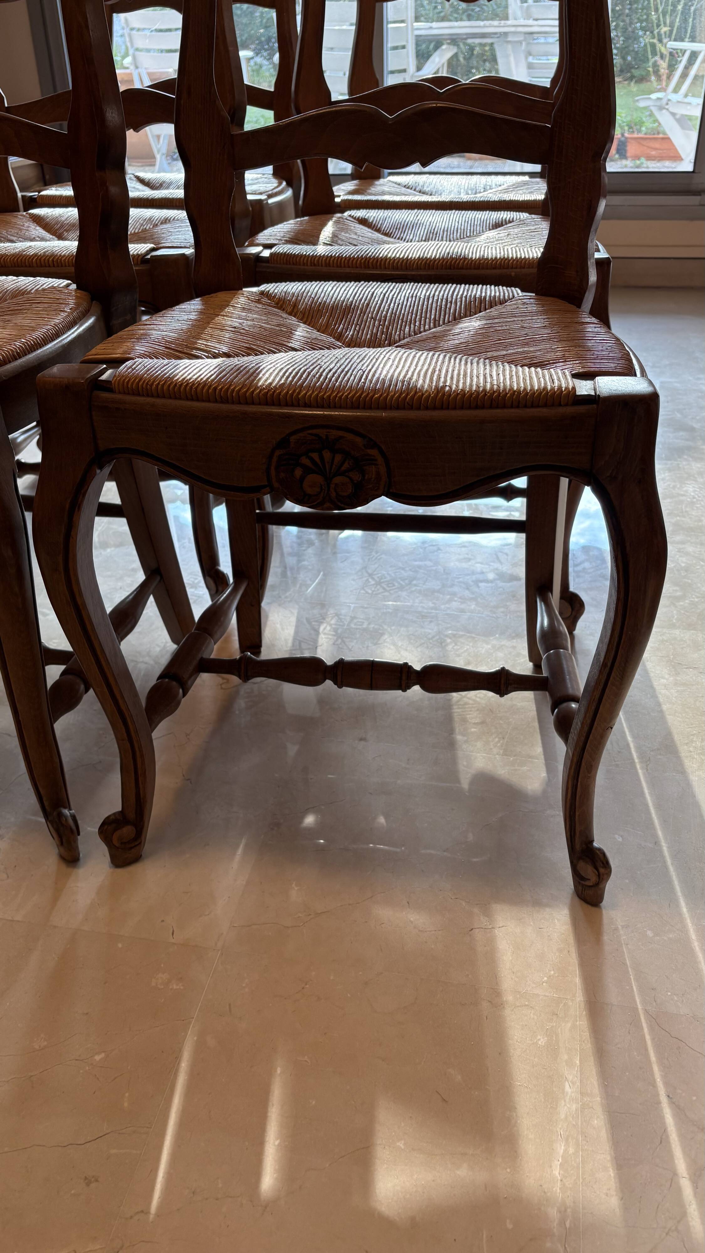 Set of 6 wooden chairs with straw seats.