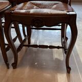 Set of 6 wooden chairs with straw seats.