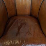 Unique vintage cognac-coloured leather club armchair with black piping