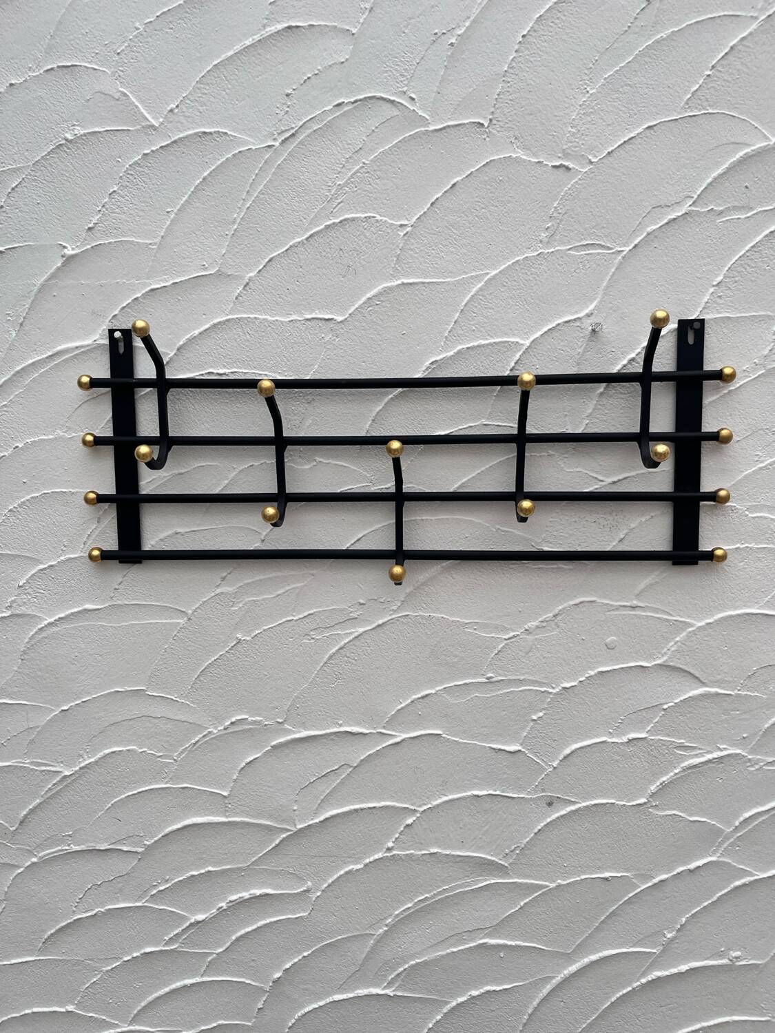 Iron and brass coat rack