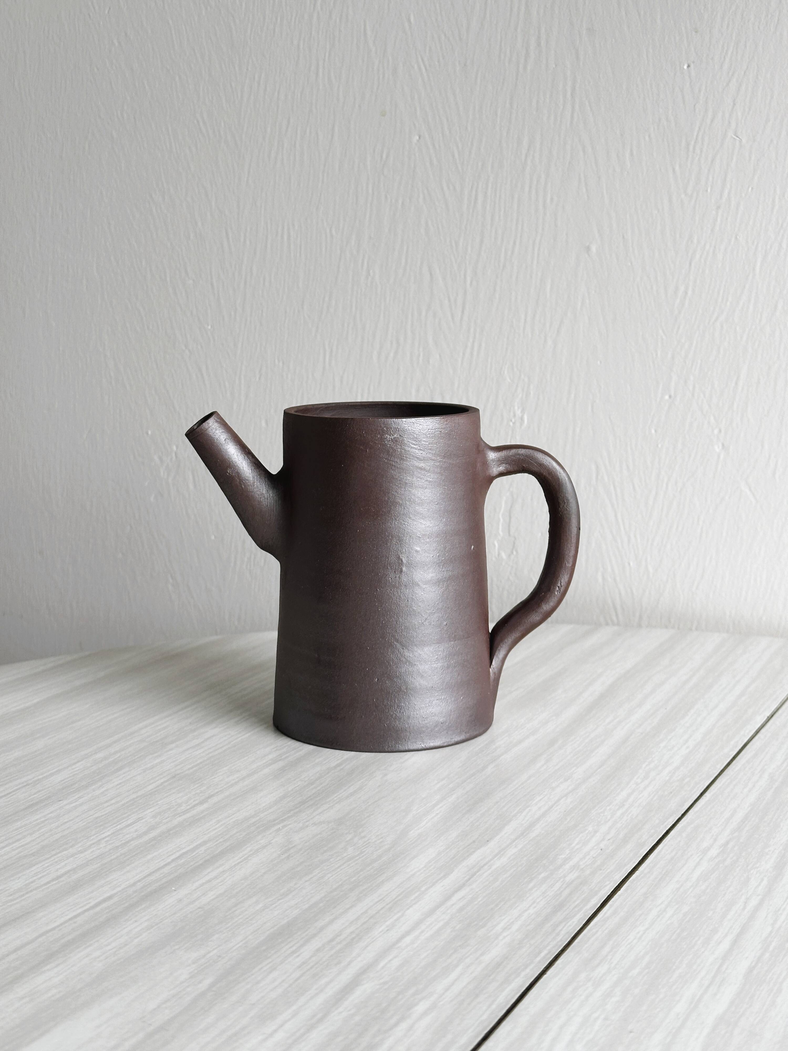 Small pitcher in brown glazed stoneware