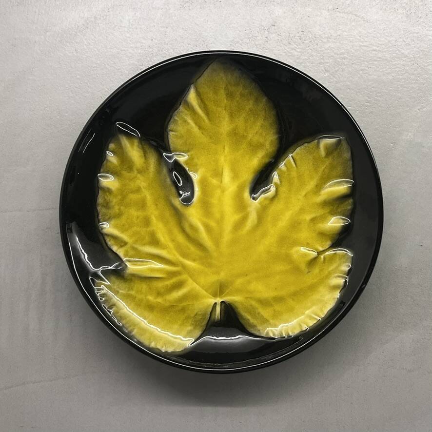 Wall plate by Pol Chambost with leaf pattern.