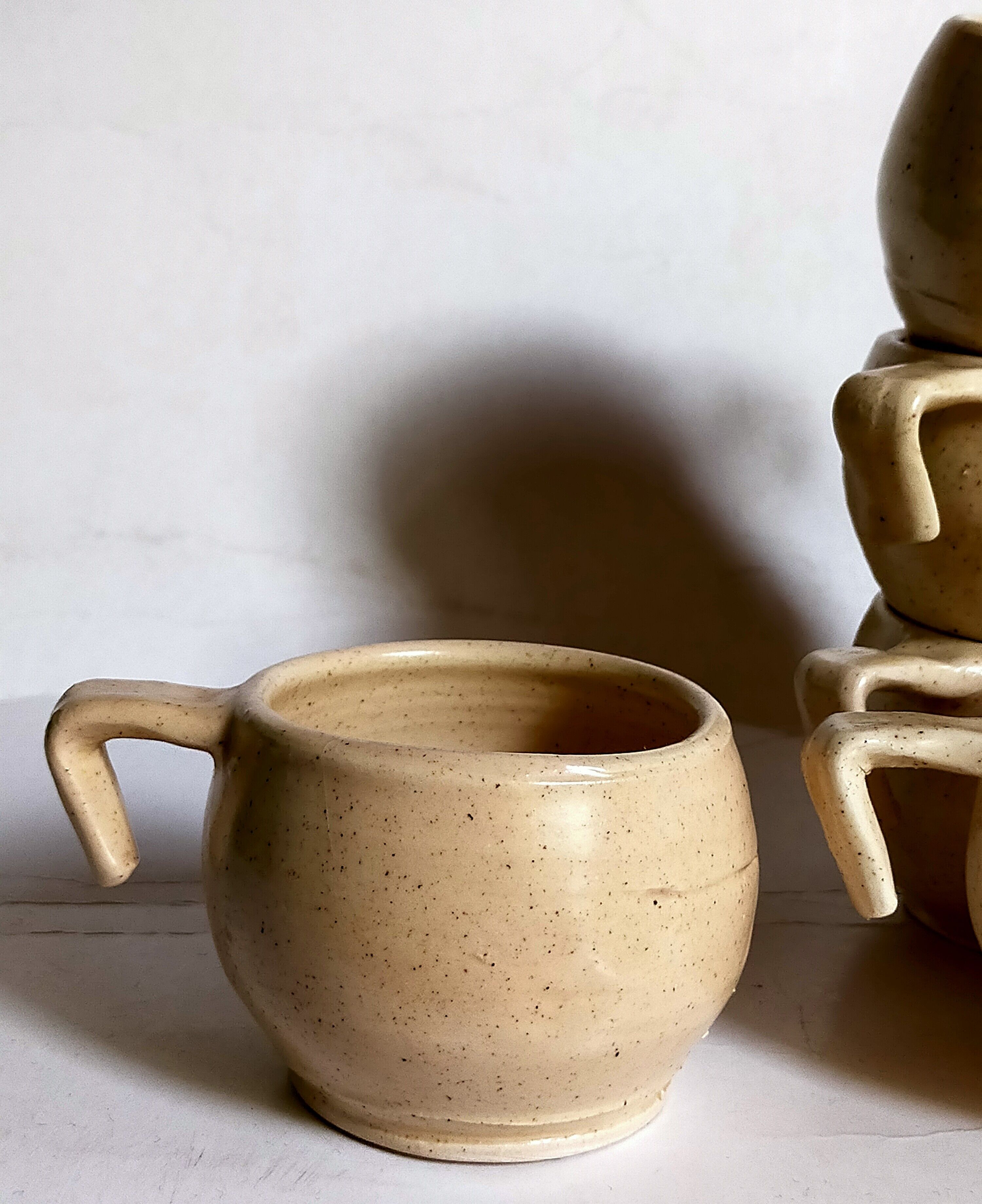 Six vintage potter's ceramic cups with vanilla enamel
