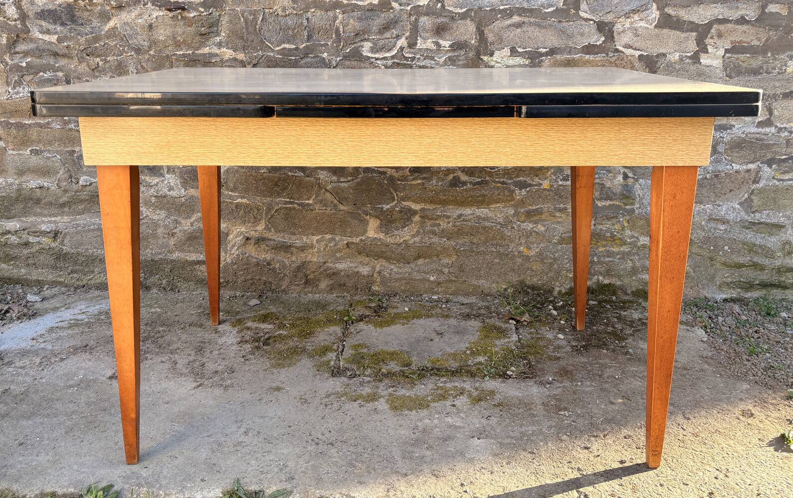Beige French modernist extendable table, wooden legs, circa 1955.