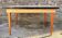 Beige French modernist extendable table, wooden legs, circa 1955.