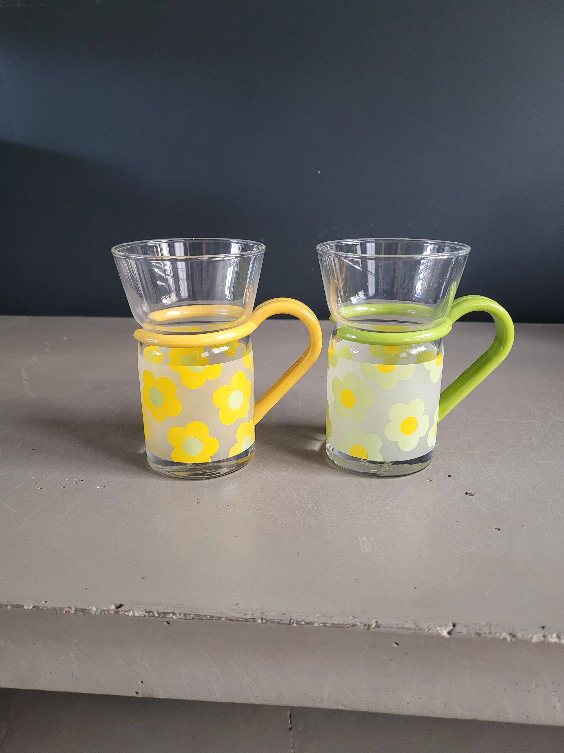 Pair of glass teacups with plastic handles