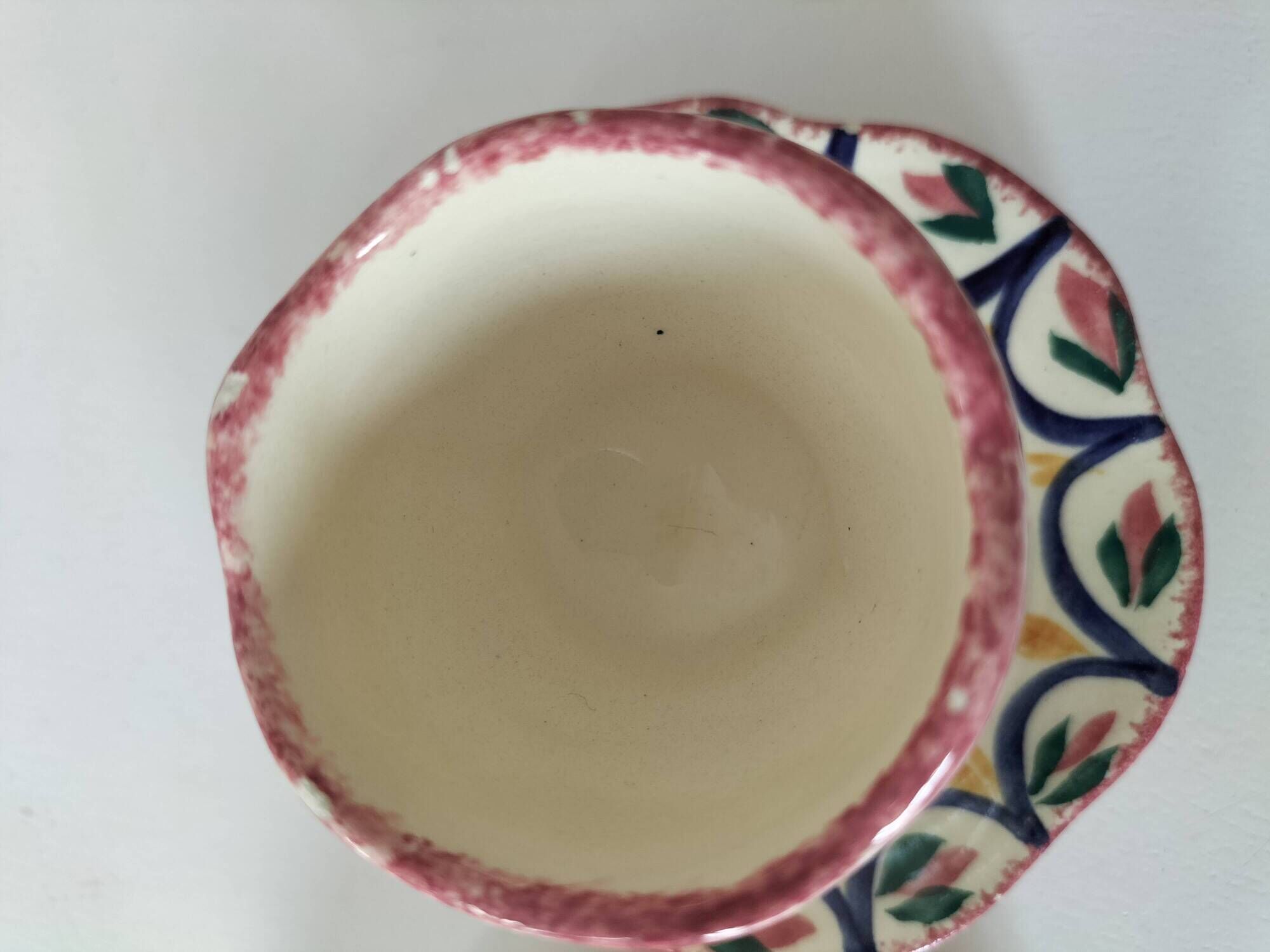 Pair of HB Quimper egg cups with integrated pedestal base, floral decoration
