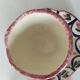 Pair of HB Quimper egg cups with integrated pedestal base, floral decoration
