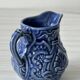 Old cream milk jug in slip