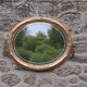 Miroir ovale vintage doré à décor floral et verre biseauté – 58 × 48 cm