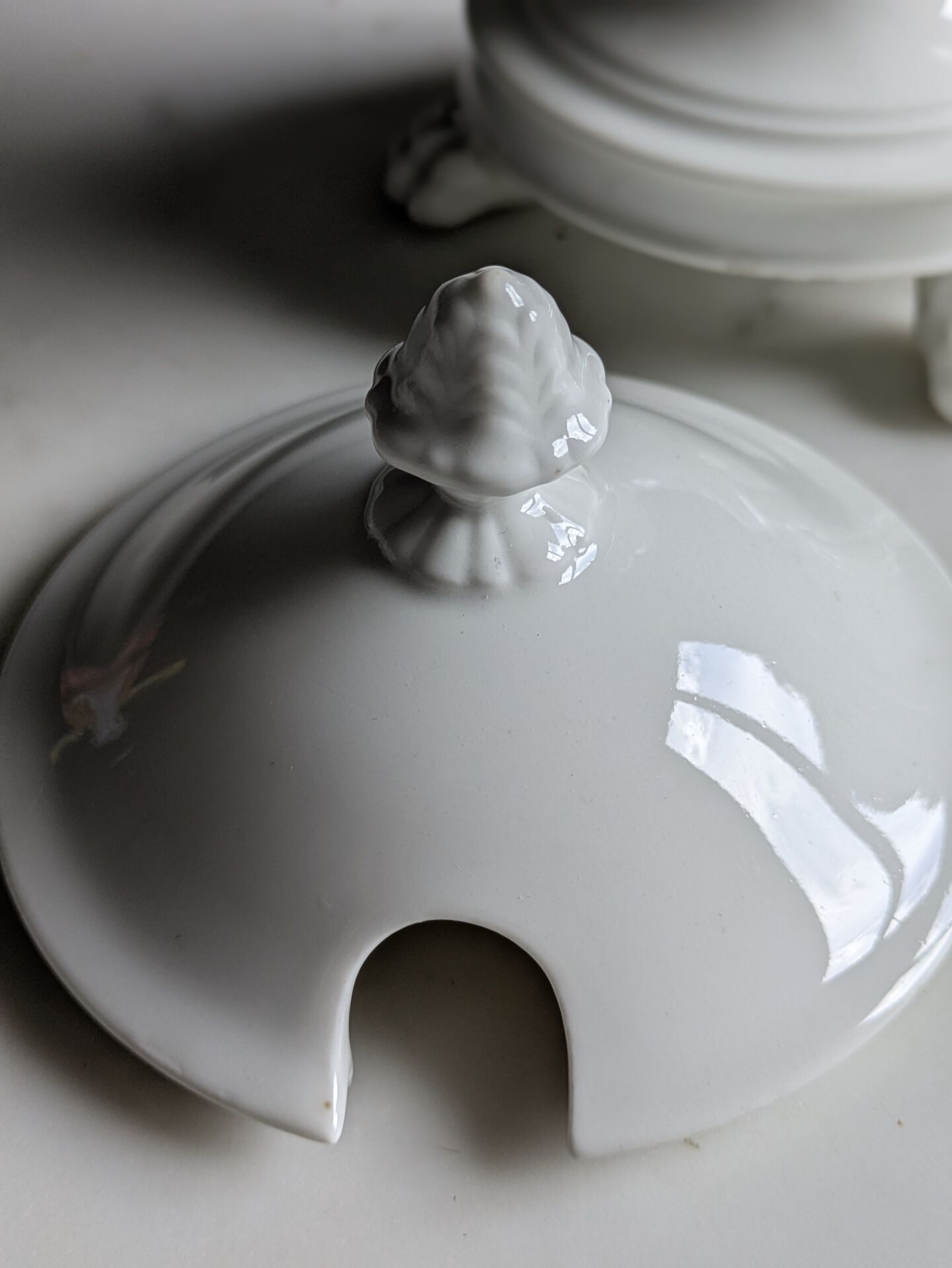 White porcelain confiturier with lion paws and masks. 19th century.
