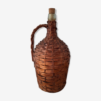 Demijohn surrounded by wicker