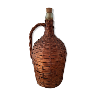 Demijohn surrounded by wicker