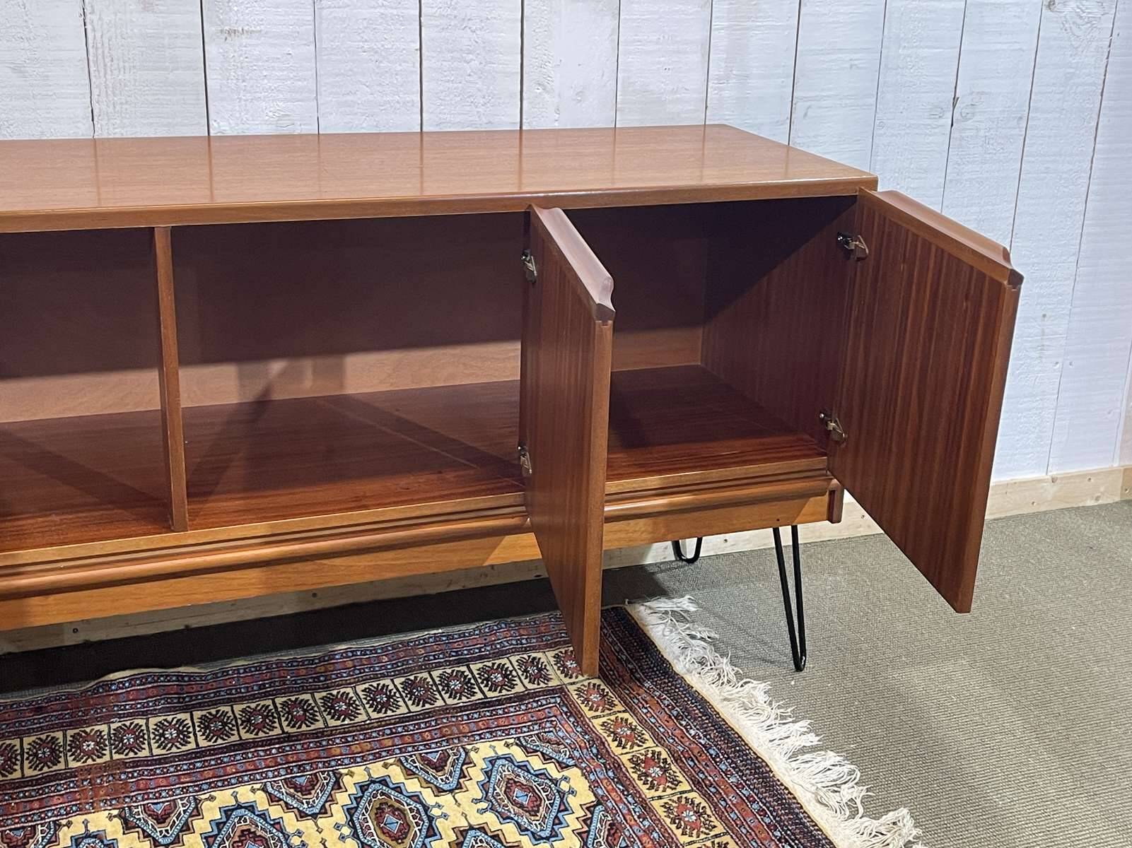 1970s English enfilade in teak with splayed legs.