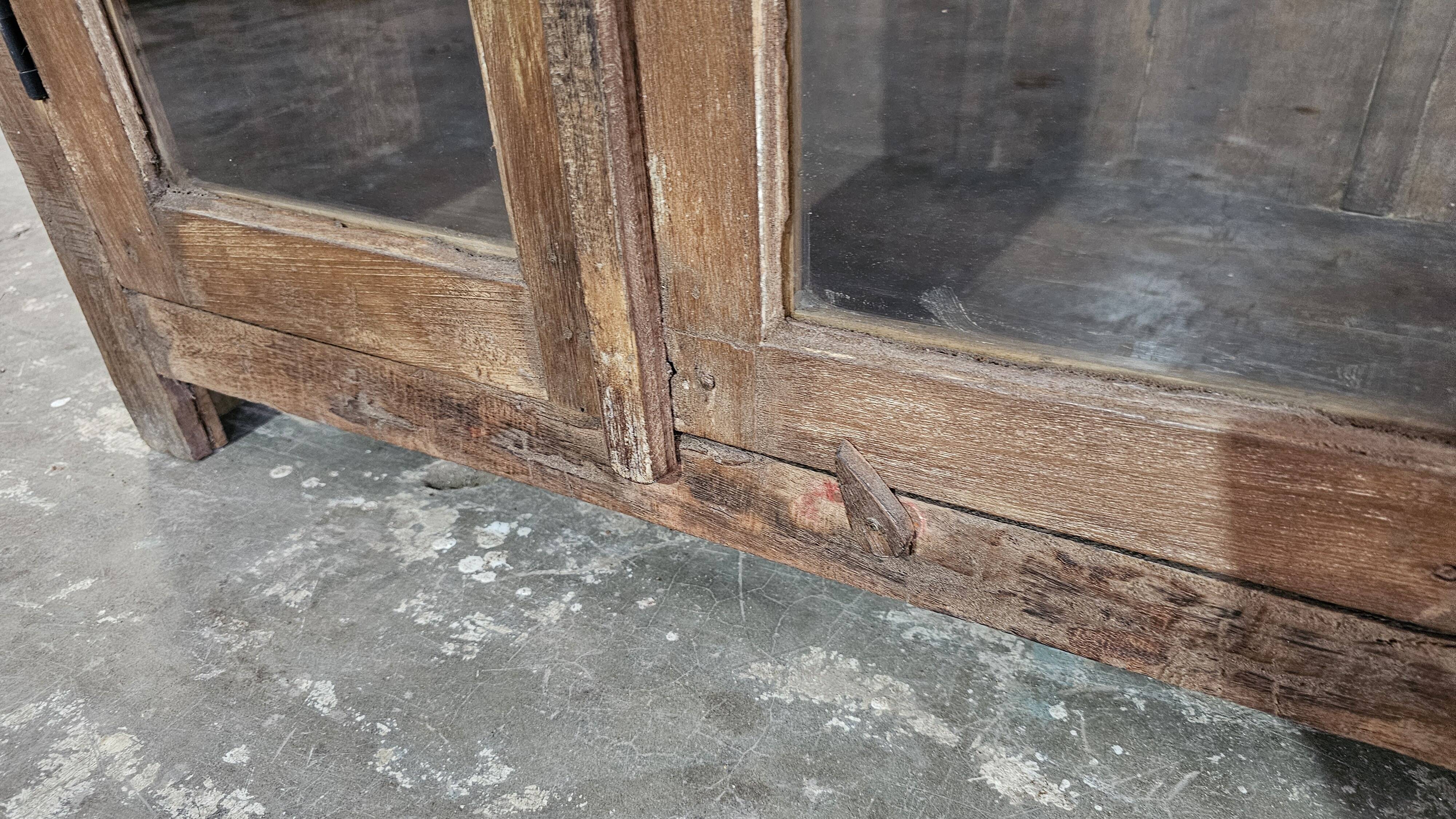 Antique glass-fronted buffet in Burmese teak