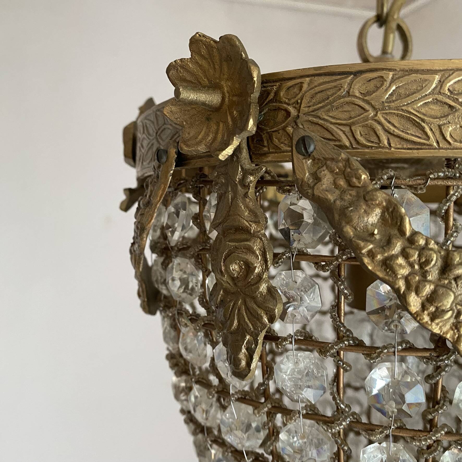 Brass basket chandelier with Louis XVI style pendants.