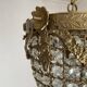 Brass basket chandelier with Louis XVI style pendants.