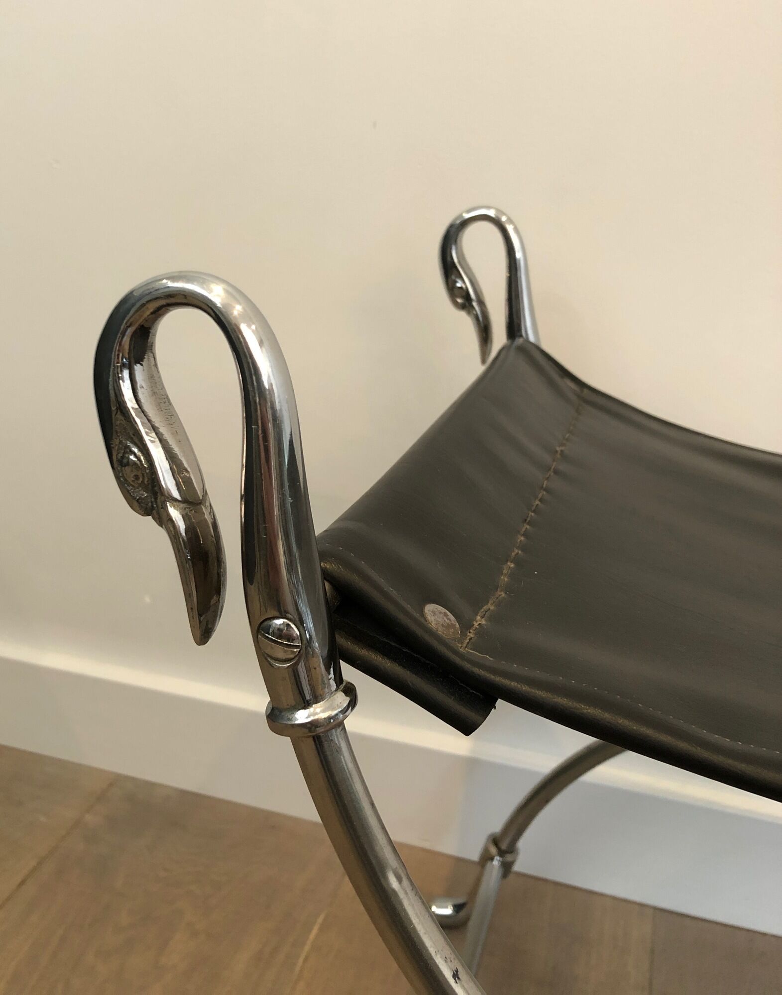 Curule stool in silver steel neoclassical style with swan heads