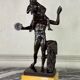 Dionysus on the shoulders of a satyr, bronze after the antique on a yellow Siena base.