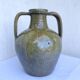 Ancient oil jar in glazed terracotta, khaki green — Auvergne, Lezou