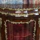 Curved display cabinet in Louis XV style with precious wood marquetry and gilded bronze.