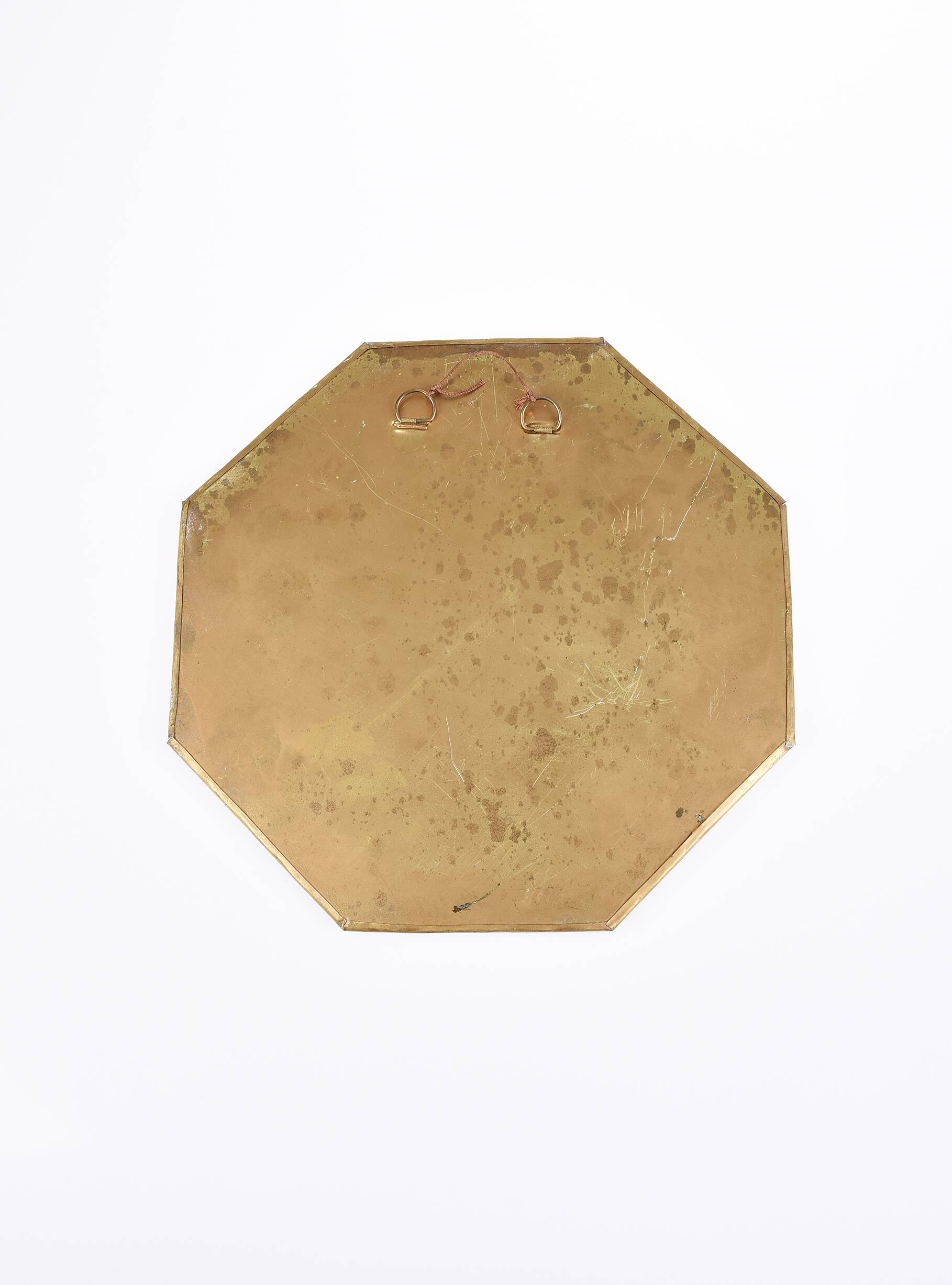 Old golden octagonal mirror, in brass