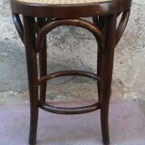 Low stool with canned seat and curved wood