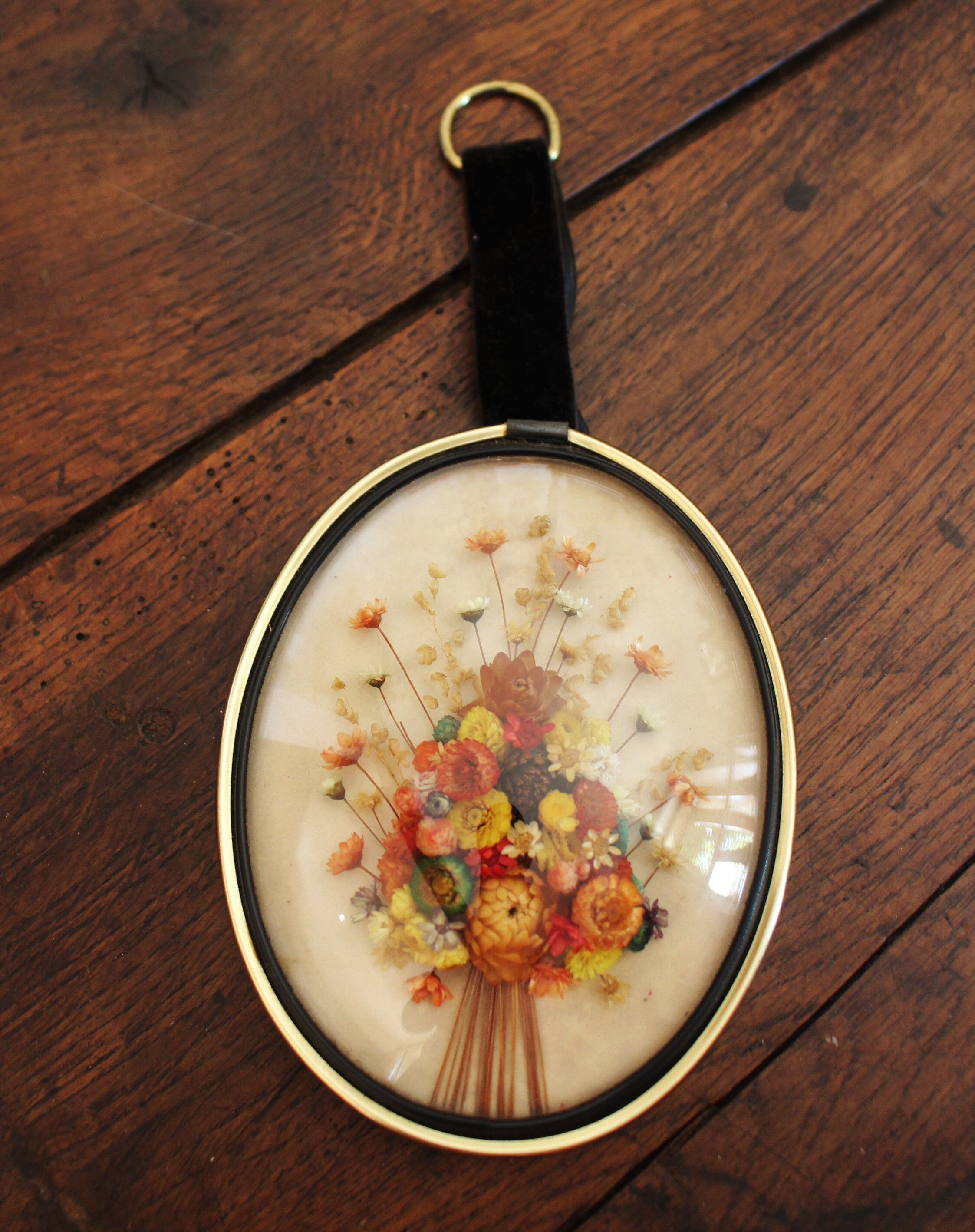 Vintage medallion domed glass dried flowers black gold
