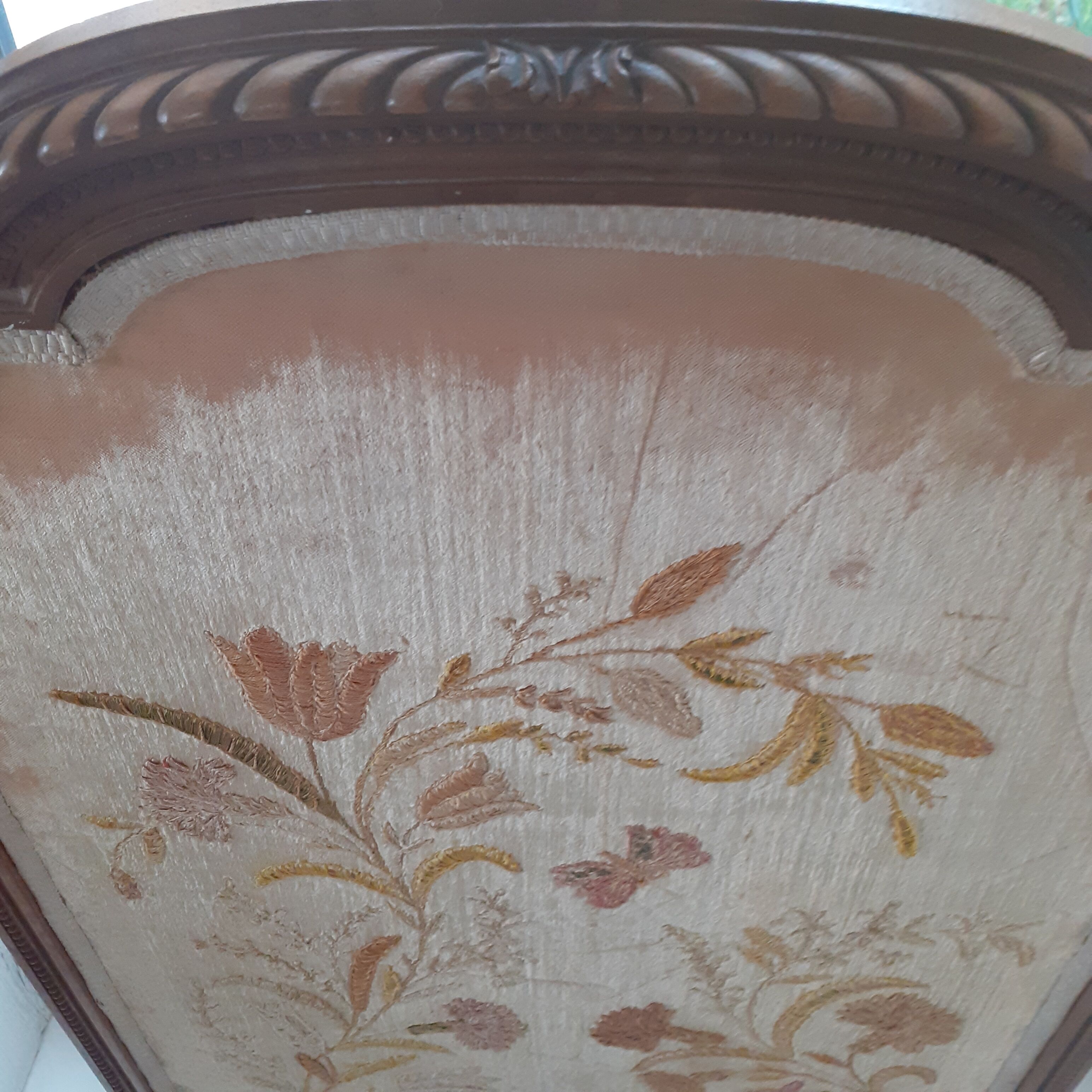 Antique fireplace screen made of wood and original fabric