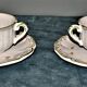Two MOUSTIER cups decorated with flowers signed