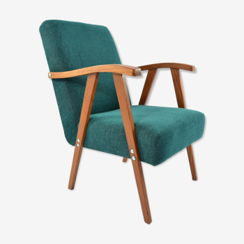 Green curved armchair