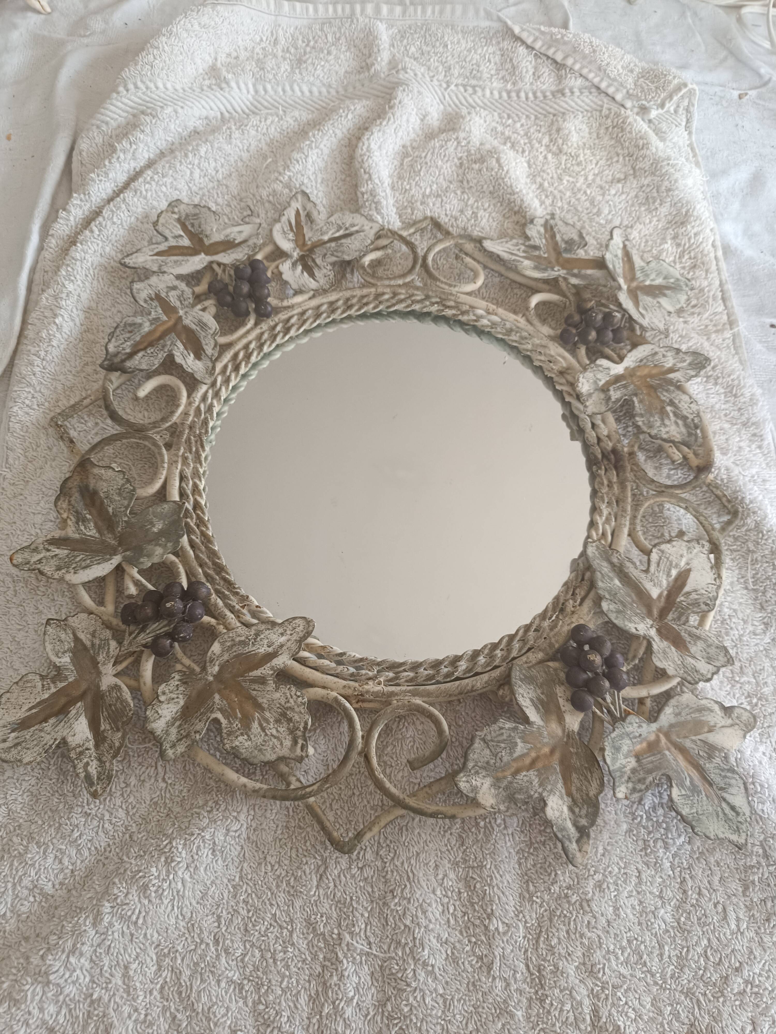Wrought iron mirror. Grape leaf decoration.