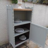 Vintage furniture of shallow depth re-enchanted in grey-green.