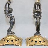 Pair of candle holders in gilded bronze and patinated with a candle