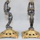 Pair of candle holders in gilded bronze and patinated with a candle