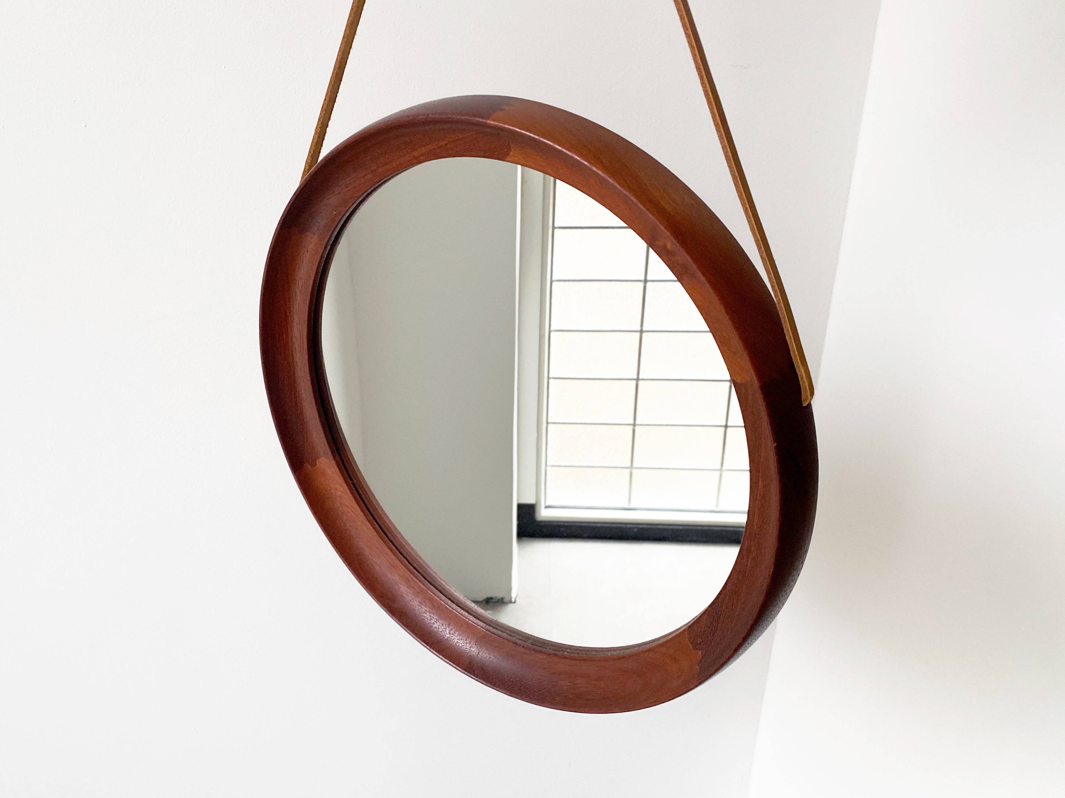 Mid Century solid teak wall mirror with a leather strap - Danish design