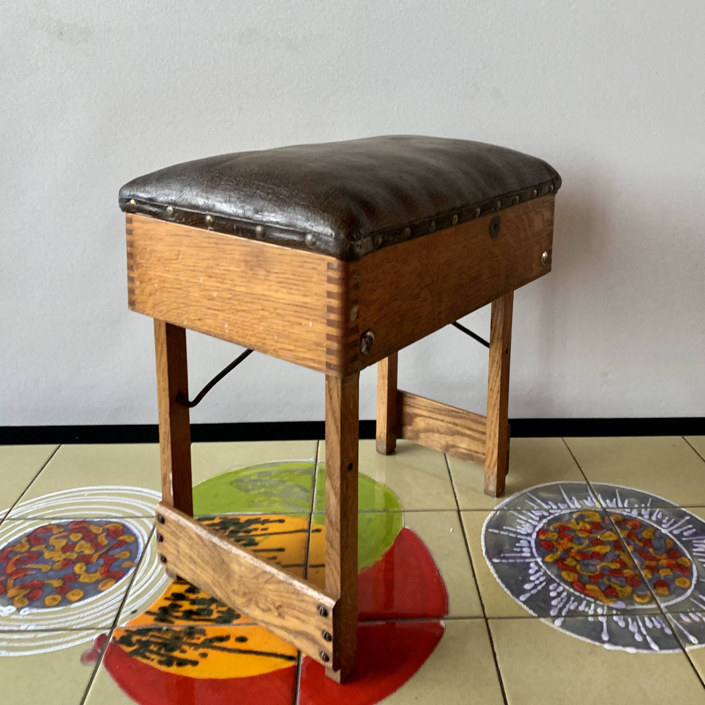Old foldable fisherman's stool in wood and leather