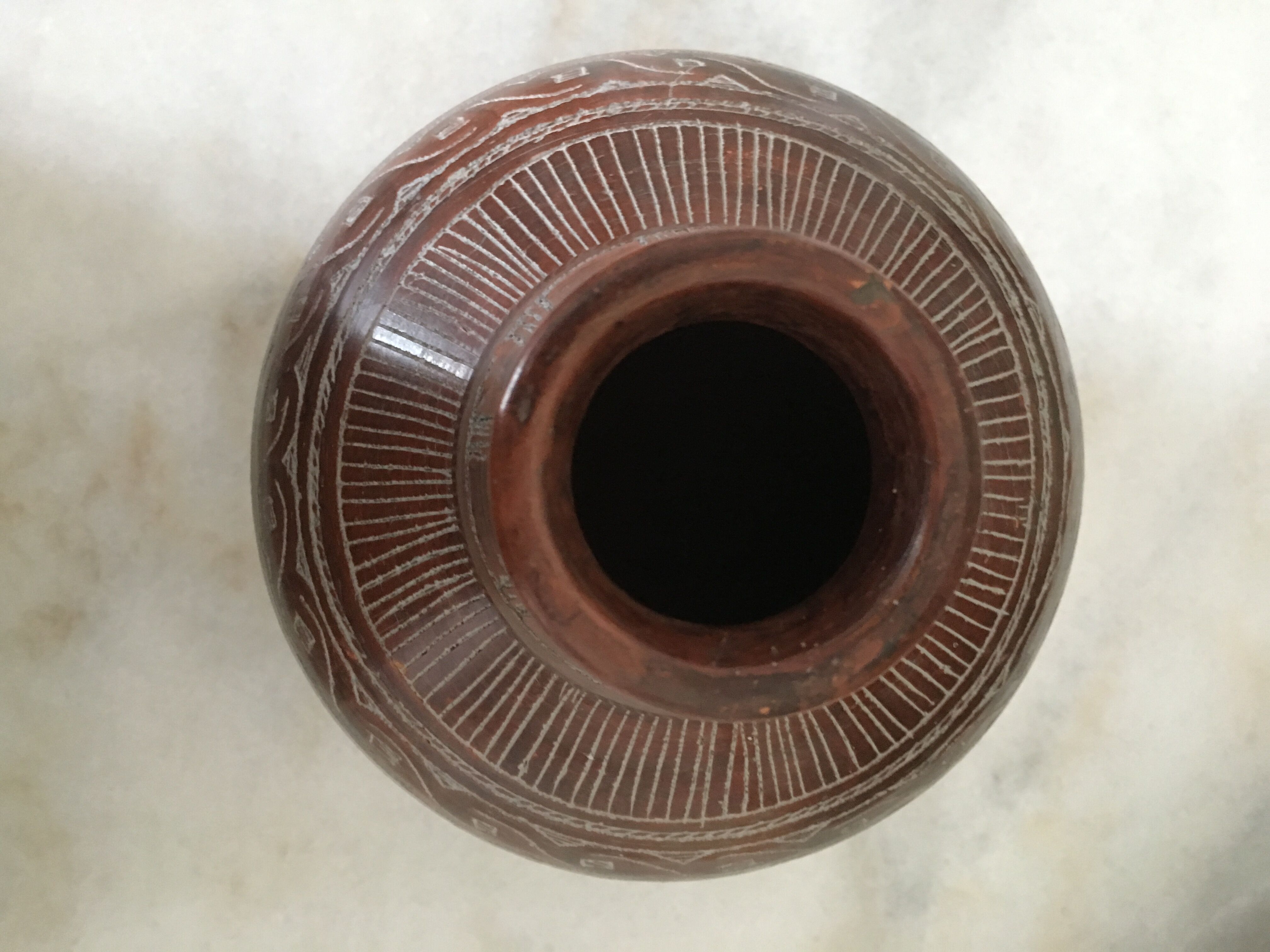 Vase in earth baked ethnic graphic patterns