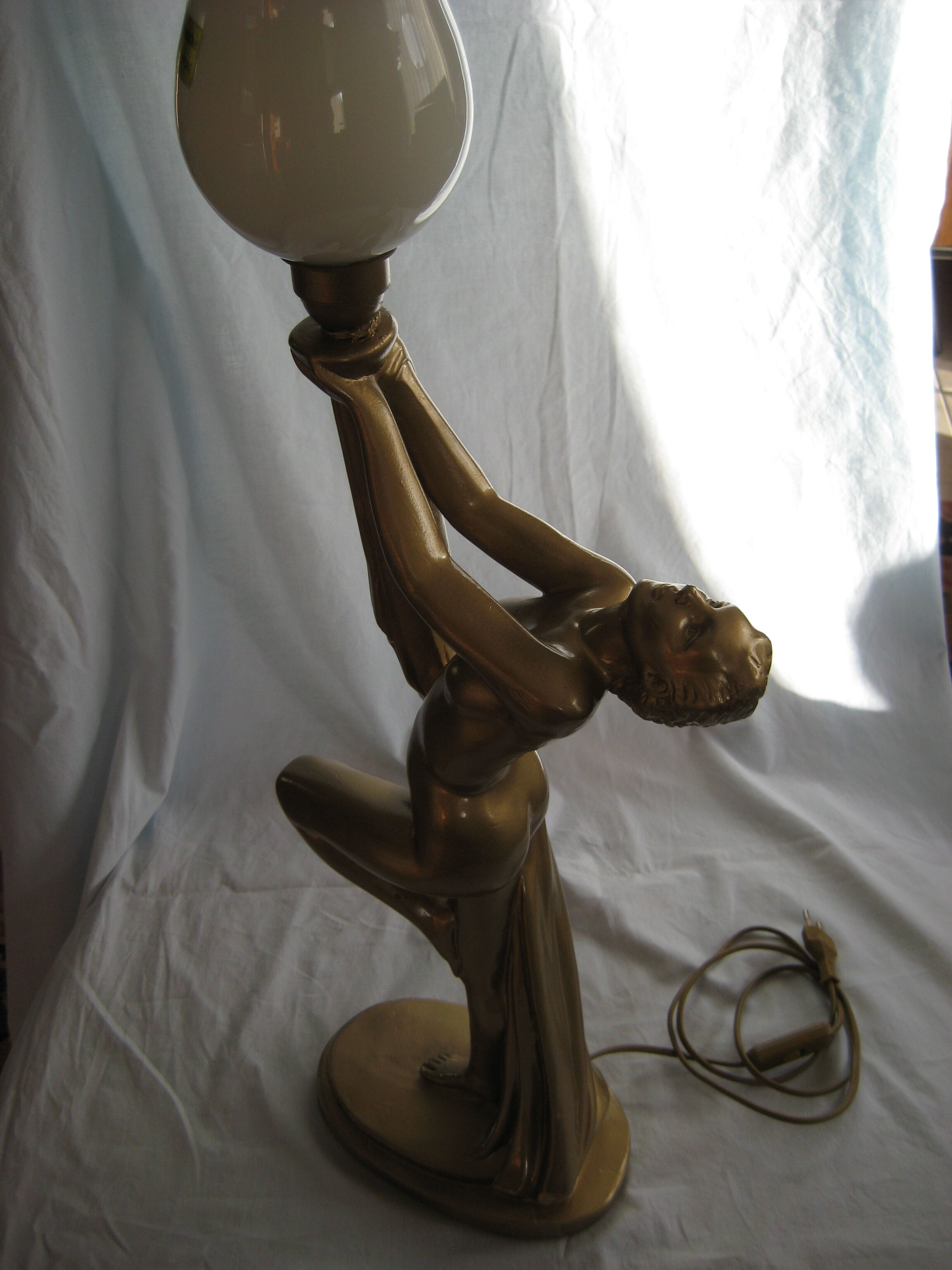 Lamp depicting a with a drape